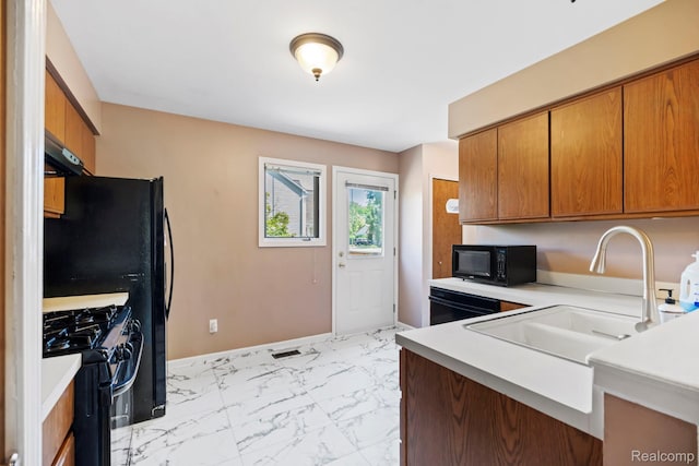 29680 Olympia Ct, Farmington Hills, MI 48336 - kitchen featuring black appliances, under cabinet range hood, light marble finish floors, light countertops, and brown cabinetry