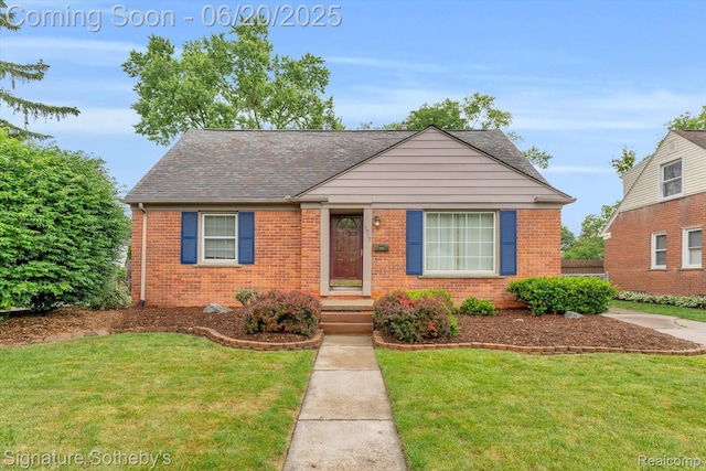 1717 Penistone St, Lake Orion, MI 48009 - view of front of property featuring brick siding, a front lawn, and a shingled roof