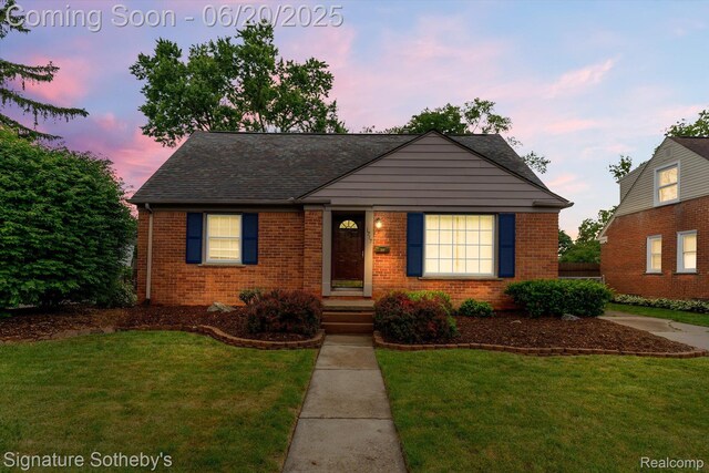 1717 Penistone St, Lake Orion, MI 48009 - view of front of home featuring brick siding, a lawn, and roof with shingles