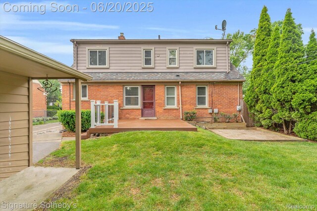 1717 Penistone St, Lake Orion, MI 48009 - back of property with a lawn, brick siding, and a wooden deck