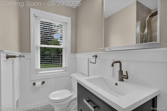 1717 Penistone St, Lake Orion, MI 48009 - full bath featuring wainscoting, vanity, a decorative wall, and an enclosed shower