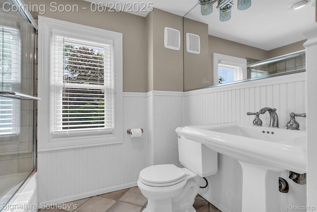 1717 Penistone St, Lake Orion, MI 48009 - bathroom featuring tile patterned flooring, shower / bath combination with glass door, and wainscoting