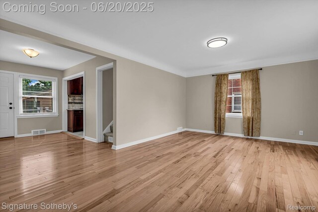 1717 Penistone St, Lake Orion, MI 48009 - empty room featuring light wood-style floors and stairway