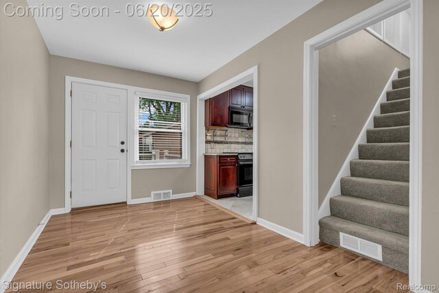 1717 Penistone St, Lake Orion, MI 48009 - foyer with light wood finished floors and stairway