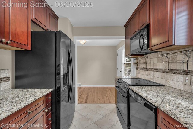 1717 Penistone St, Lake Orion, MI 48009 - kitchen with black appliances, decorative backsplash, light stone counters, and dark brown cabinets