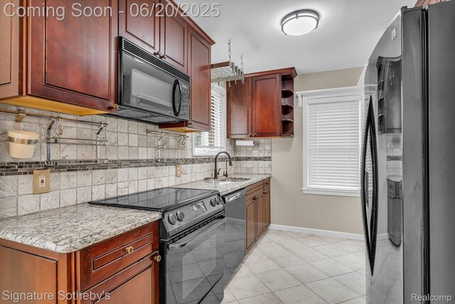 1717 Penistone St, Lake Orion, MI 48009 - kitchen featuring black appliances, decorative backsplash, open shelves, and light stone countertops