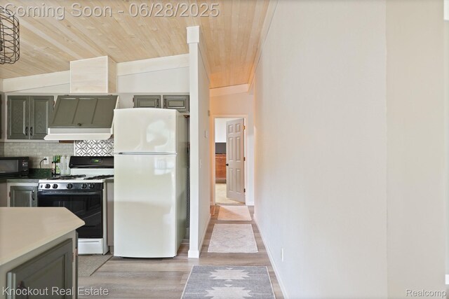 6275 Caine Rd, Vassar, MI 48768 - kitchen featuring white appliances, wood ceiling, backsplash, light wood-style flooring, and vaulted ceiling