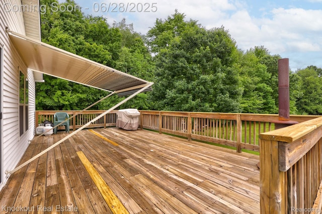 6275 Caine Rd, Vassar, MI 48768 - deck with a grill and view of wooded area