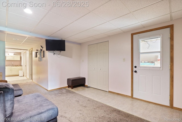 6275 Caine Rd, Vassar, MI 48768 - carpeted living area featuring a paneled ceiling and baseboards