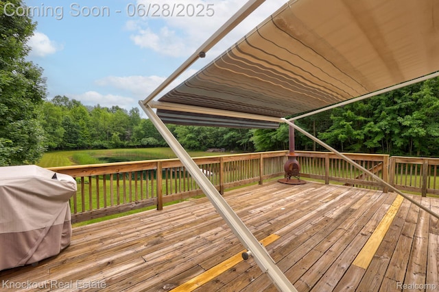 6275 Caine Rd, Vassar, MI 48768 - wooden terrace with a grill and view of wooded area