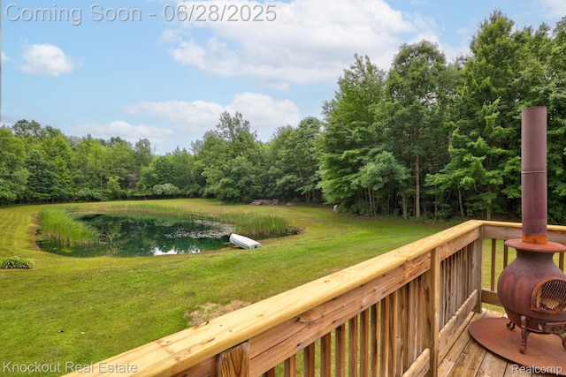 6275 Caine Rd, Vassar, MI 48768 - deck with a yard, a water view, and a view of trees