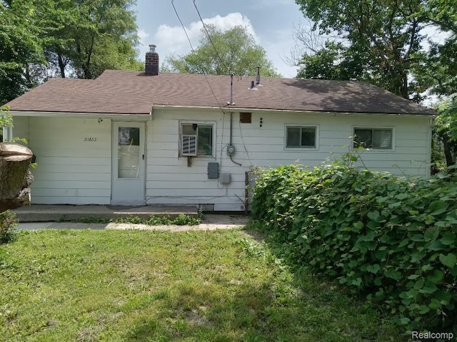 31612 Antrim Ct, Westland, MI 48186 - back of house featuring a lawn, a chimney, and roof with shingles