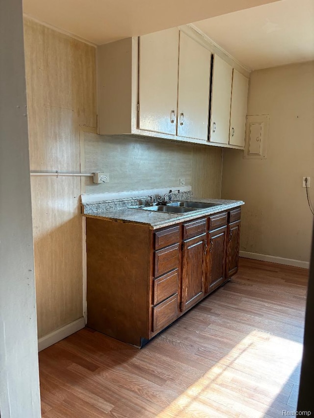 31612 Antrim Ct, Westland, MI 48186 - kitchen with light wood-style floors, light countertops, white cabinets, and backsplash
