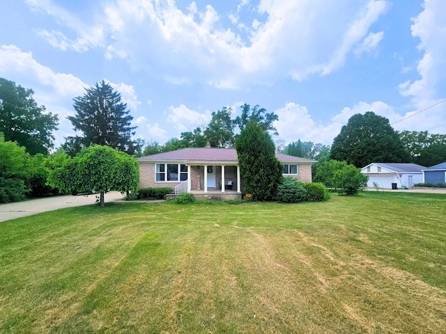 5365 Flushing Rd, Flushing, MI 48433 - single story home with covered porch, a front lawn, and brick siding