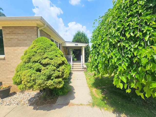 5365 Flushing Rd, Flushing, MI 48433 - doorway to property with a porch and brick siding