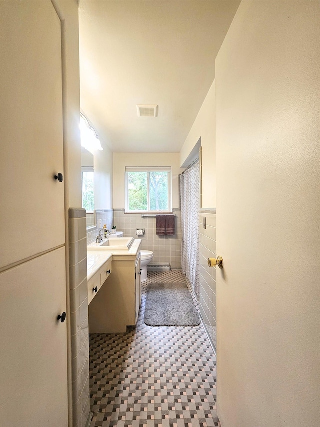 5365 Flushing Rd, Flushing, MI 48433 - full bath with tile walls, vanity, and wainscoting
