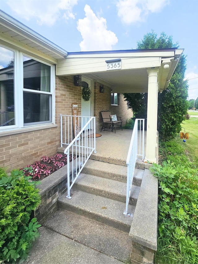 5365 Flushing Rd, Flushing, MI 48433 - doorway to property with brick siding and covered porch
