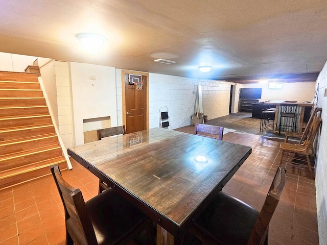 5365 Flushing Rd, Flushing, MI 48433 - tiled dining space featuring stairway and concrete block wall