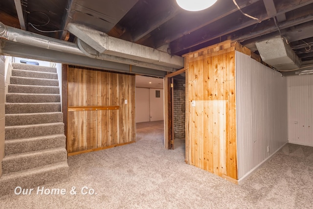 1716 Sycamore St, Saginaw, MI 48602 - basement featuring wooden walls, stairs, and carpet flooring