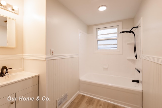 1716 Sycamore St, Saginaw, MI 48602 - bathroom featuring wainscoting, vanity, wood finished floors, and shower / washtub combination