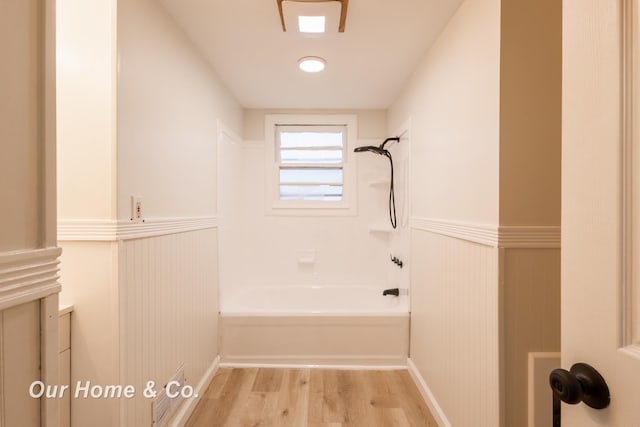 1716 Sycamore St, Saginaw, MI 48602 - full bathroom with wainscoting, wood finished floors, and shower / tub combination