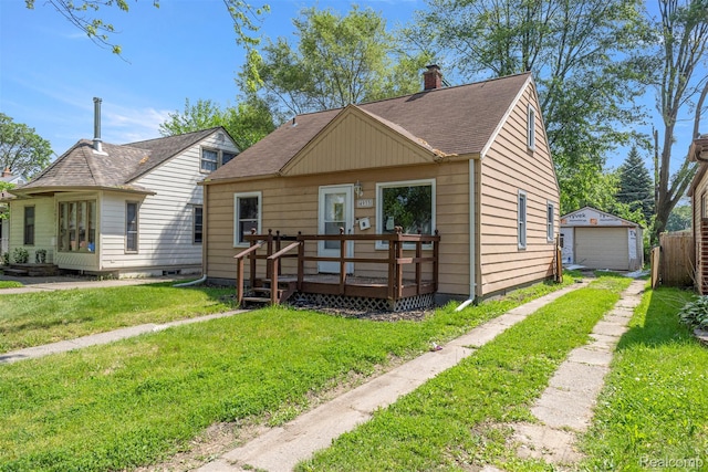 4933 Ziegler St, Dearborn Heights, MI 48125 - bungalow-style home with a deck, driveway, a chimney, a front yard, and a detached garage