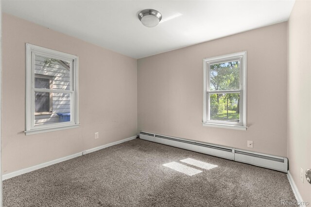 4933 Ziegler St, Dearborn Heights, MI 48125 - carpeted spare room featuring a baseboard heating unit and baseboards