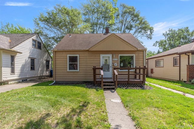 4933 Ziegler St, Dearborn Heights, MI 48125 - bungalow-style home featuring a front yard, roof with shingles, and a deck