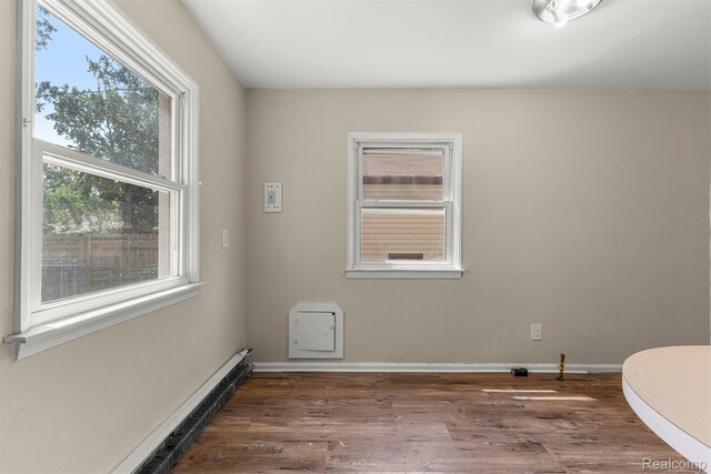 4933 Ziegler St, Dearborn Heights, MI 48125 - spare room with baseboard heating and wood finished floors