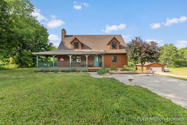 8651 22 Mile Rd NE, Sand Lake, MI 49343 - view of front of home featuring an outdoor structure, covered porch, a chimney, a front lawn, and a detached garage