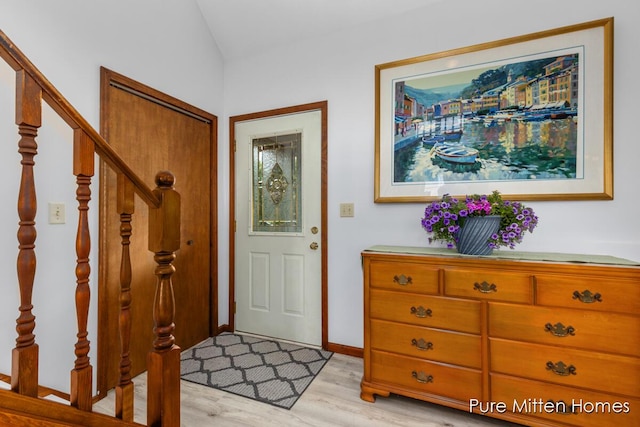 8651 22 Mile Rd NE, Sand Lake, MI 49343 - entryway featuring light wood finished floors, stairway, and vaulted ceiling