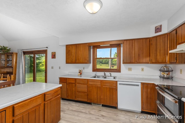 8651 22 Mile Rd NE, Sand Lake, MI 49343 - kitchen with dishwasher, double oven range, brown cabinetry, and light countertops