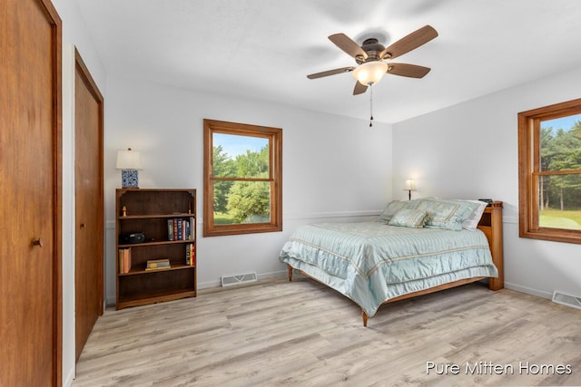 8651 22 Mile Rd NE, Sand Lake, MI 49343 - bedroom featuring wood finished floors, a closet, and ceiling fan