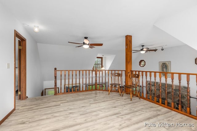 8651 22 Mile Rd NE, Sand Lake, MI 49343 - sitting room with ceiling fan, wood finished floors, an upstairs landing, and rail lighting