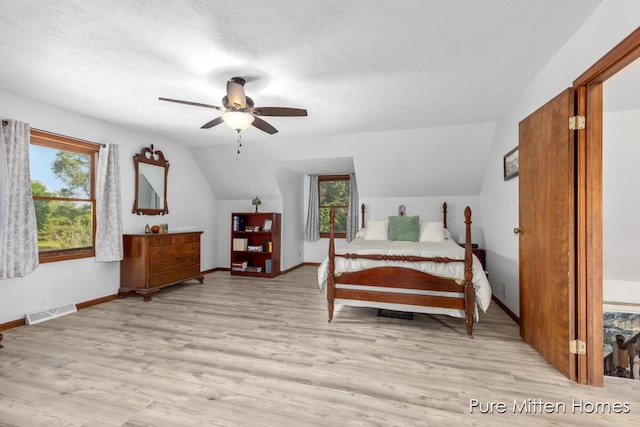 8651 22 Mile Rd NE, Sand Lake, MI 49343 - bedroom with vaulted ceiling, light wood-type flooring, and ceiling fan