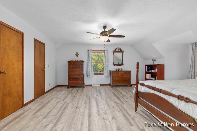 8651 22 Mile Rd NE, Sand Lake, MI 49343 - bedroom with light wood-style flooring, ceiling fan, and lofted ceiling