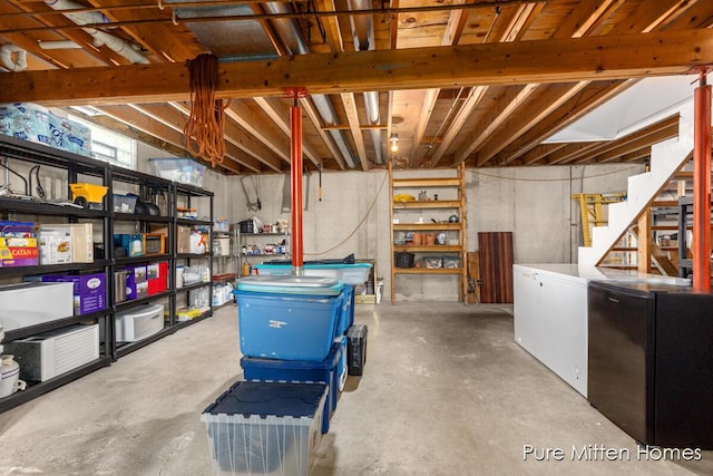 8651 22 Mile Rd NE, Sand Lake, MI 49343 - basement featuring freestanding refrigerator and stairway