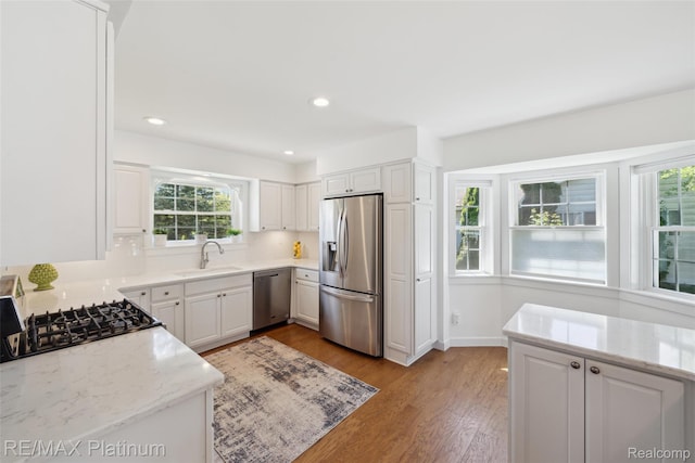 13368 N Fenton Rd, Fenton, MI 48430 - kitchen with stainless steel appliances, light wood finished floors, white cabinetry, light stone countertops, and recessed lighting