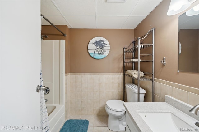 13368 N Fenton Rd, Fenton, MI 48430 - full bath featuring tile walls, vanity, tile patterned flooring, a wainscoted wall, and washtub / shower combination