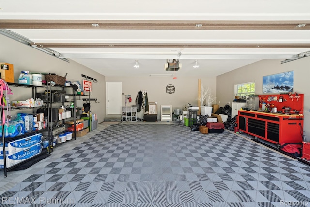 13368 N Fenton Rd, Fenton, MI 48430 - garage with a garage door opener and a workshop area