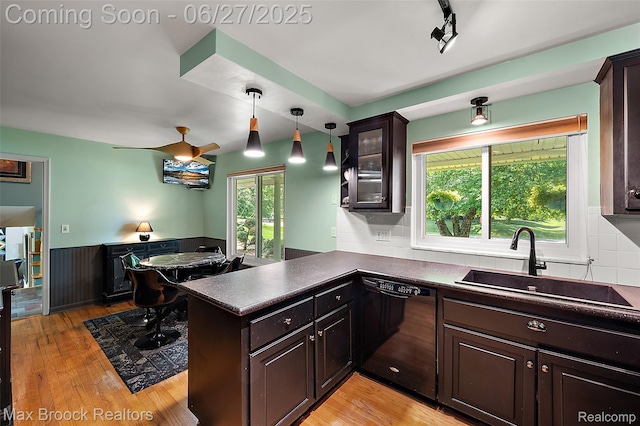 7189 Lindenmere Dr, Bloomfield Hills, MI 48301 - kitchen with black dishwasher, dark countertops, dark brown cabinetry, light wood-style floors, and wainscoting