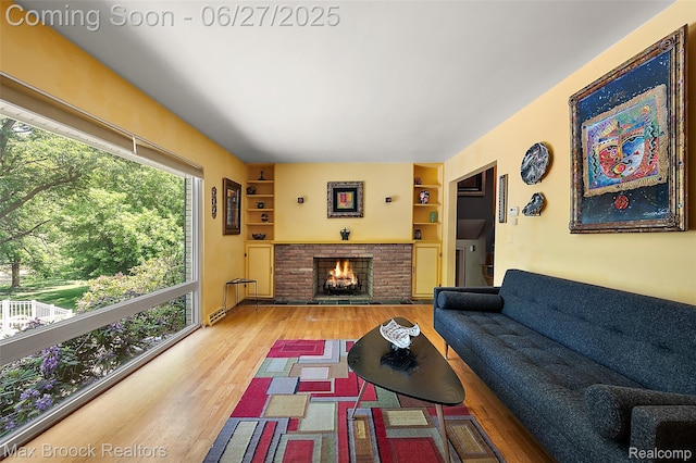 7189 Lindenmere Dr, Bloomfield Hills, MI 48301 - living room with wood finished floors, a fireplace, and built in features