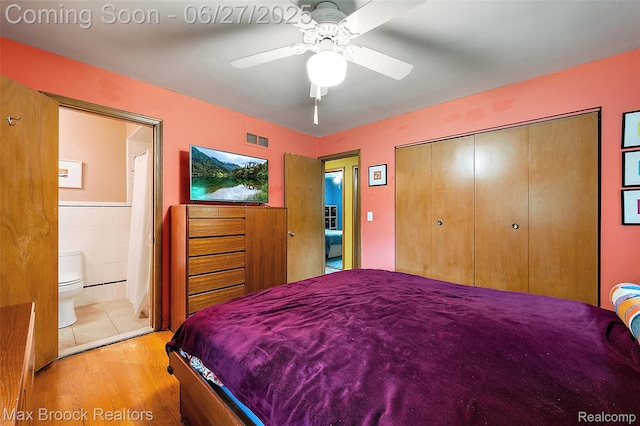 7189 Lindenmere Dr, Bloomfield Hills, MI 48301 - bedroom with wood finished floors, a closet, ensuite bathroom, ceiling fan, and tile walls