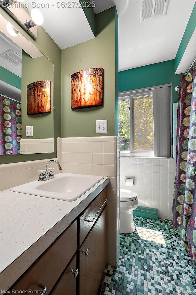 7189 Lindenmere Dr, Bloomfield Hills, MI 48301 - full bathroom with tile walls, vanity, wainscoting, and tile patterned flooring