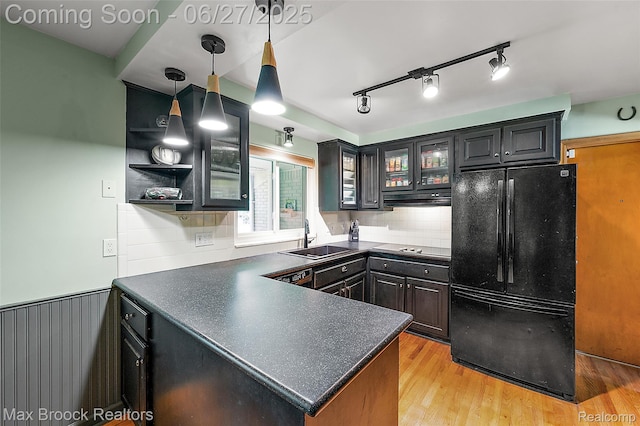 7189 Lindenmere Dr, Bloomfield Hills, MI 48301 - kitchen with black appliances, dark countertops, a peninsula, range hood, and glass insert cabinets