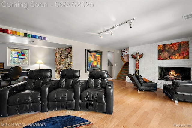 7189 Lindenmere Dr, Bloomfield Hills, MI 48301 - home theater room featuring wood finished floors, a fireplace, and rail lighting