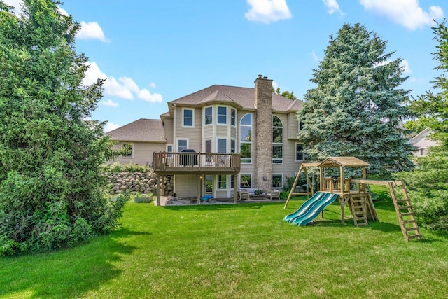 7639 Dunross Dr, Portage, MI 49024 - rear view of property with a chimney, a playground, a yard, and a wooden deck