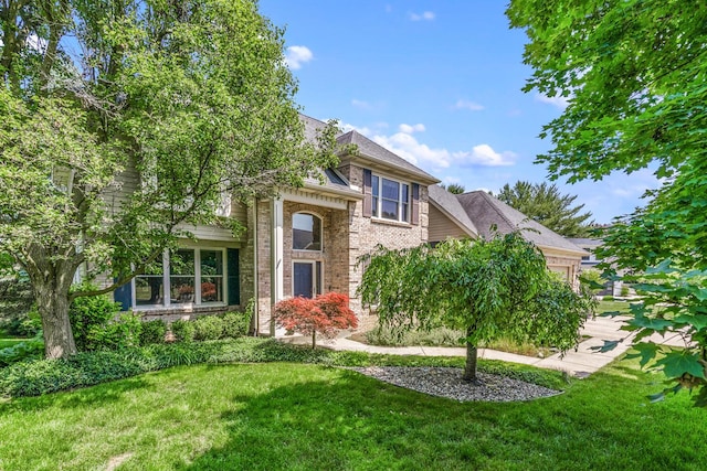 7639 Dunross Dr, Portage, MI 49024 - view of front of home featuring an attached garage, a front lawn, and brick siding