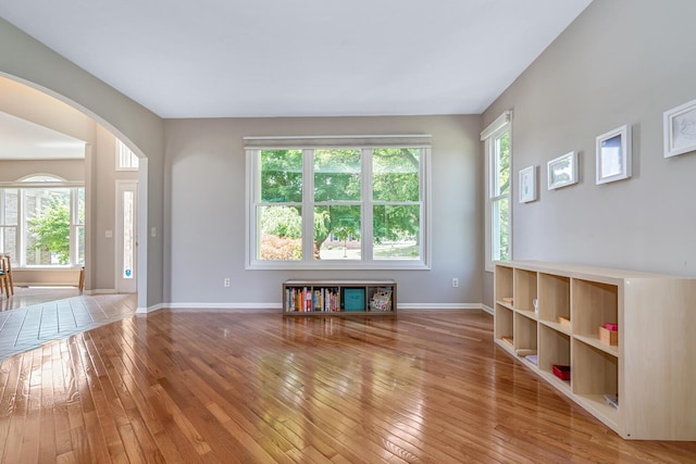 7639 Dunross Dr, Portage, MI 49024 - unfurnished living room with arched walkways and hardwood / wood-style floors