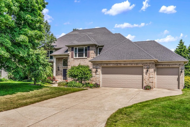 7639 Dunross Dr, Portage, MI 49024 - view of front facade with an attached garage, concrete driveway, a front lawn, and brick siding